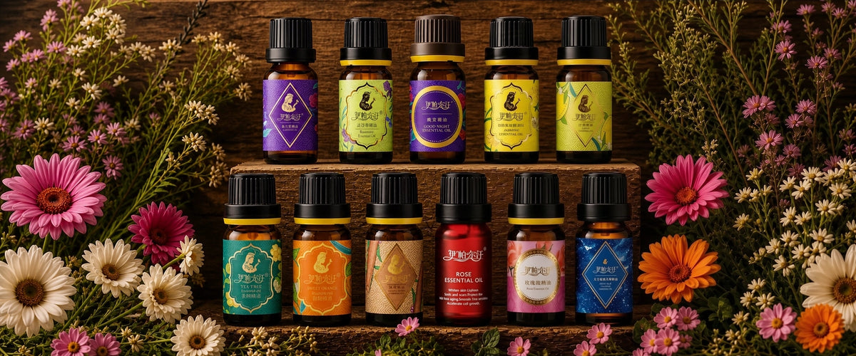 Wide horizontal product banner of full Iparhan essential oil range, 12 kinds of amber glass aromatic bottles with unique color labels, arranged on rustic wooden tiers framed by fresh daisies and gerbera flowers, premium Xinjiang botanical lavender, rose, tea tree, sweet orange aromatherapy oils for skincare & diffuser